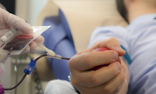 947303506
Doctor collecting samples while a volunteer  gives  blood